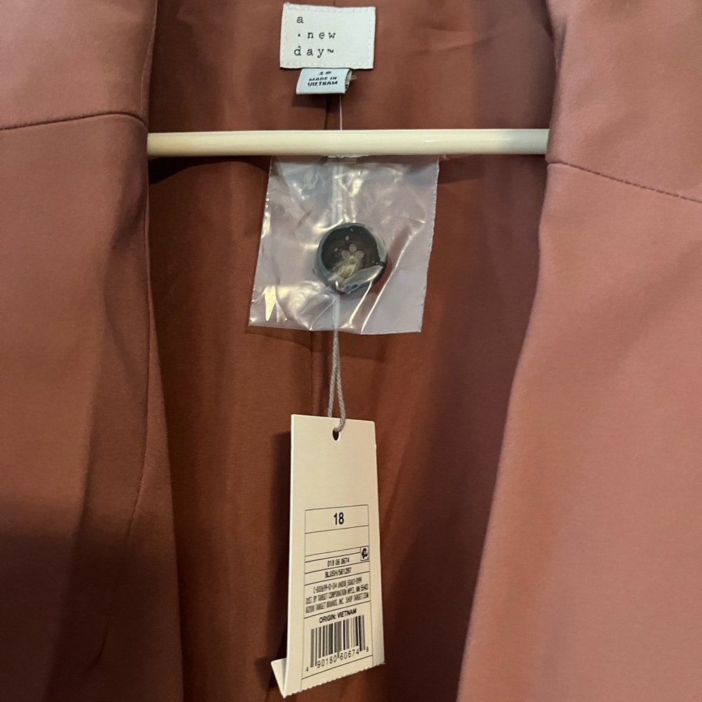 A new day. Brand new, with tags. Rose colored blazer. Women’s 18